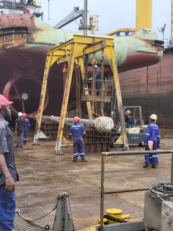 Propeller shaft being lifted during marine project work